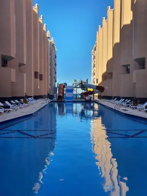 a swimming pool in the middle of a city at Juliana Beach Resort AG01 in Hurghada