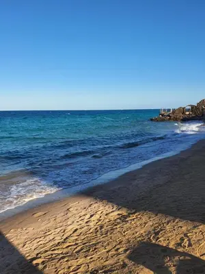 a sandy beach with the ocean in the background at Juliana Beach Resort AG01 in Hurghada