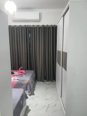 a room with two beds and black curtains at Juliana Beach Resort AG01 in Hurghada