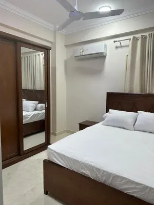 a bedroom with a large bed and a mirror at فيلا ايلا ترافيل in Luxor