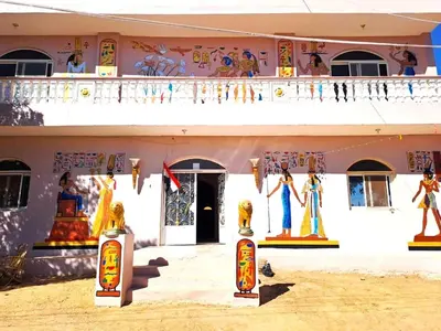 a building with paintings on the side of it at MAGIC GUEST HOUSE - Δ Relax Pur Δ 15 MiN TO ASWAN in Aswan