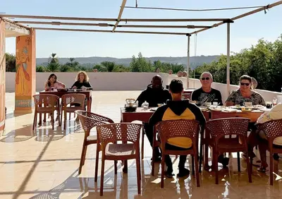 a group of people sitting at tables on a patio at MAGIC GUEST HOUSE - Δ Relax Pur Δ 15 MiN TO ASWAN in Aswan