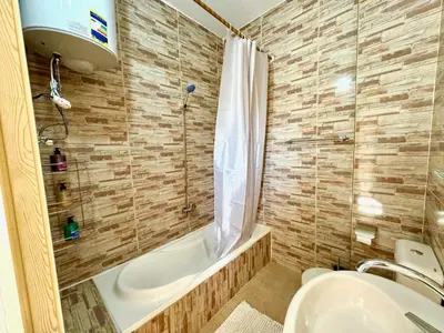 a bathroom with a tub and a sink and a shower at MAGIC GUEST HOUSE - Δ Relax Pur Δ 15 MiN TO ASWAN in Aswan