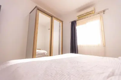 a bedroom with a white bed and a mirror at Lazur Pool Apartment's - El Kawsar, Hurghada - Egypt in Hurghada