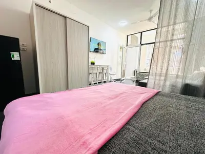a large pink bed in a bedroom with a window at Falcon Loft Studio Sheraton Road in Hurghada