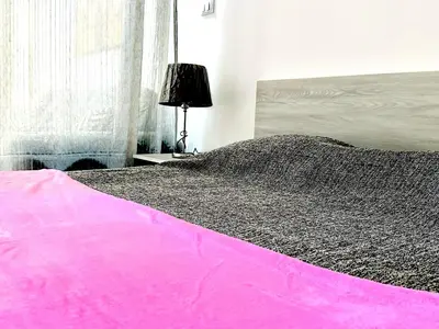 a bedroom with a bed with a pink blanket at Falcon Loft Studio Sheraton Road in Hurghada