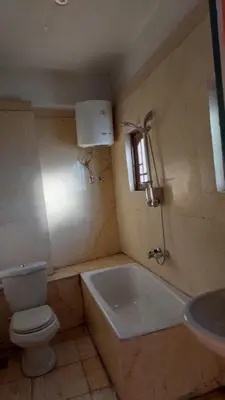a bathroom with a toilet and a tub and a sink at The Best View With Great Location 2 Bedroom Apartment in Luxor in Luxor