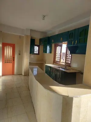 a kitchen with green cabinets and a counter top at The Best View With Great Location 2 Bedroom Apartment in Luxor in Luxor