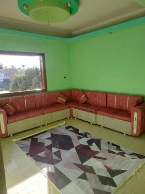 a living room with a red couch and a window at The Best View With Great Location 2 Bedroom Apartment in Luxor in Luxor