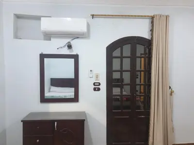 a room with a door and a mirror at El Quarn Apartment in ‘Ezbet Abu Ḥabashi