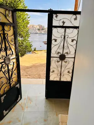 an open door with a view of the water at Mido Tag in Aswan