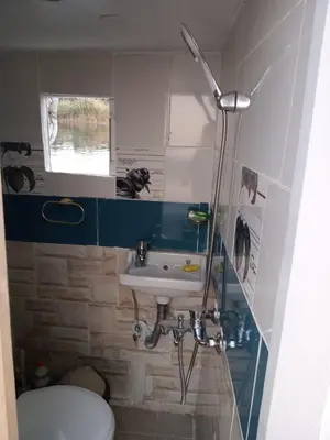 a small bathroom with a sink and a toilet at Nuba Tod Sailling boat in Aswan