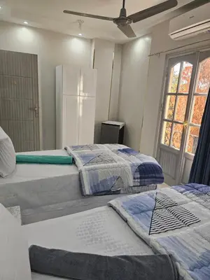 two beds sitting next to each other in a room at King Mina Nubian House in Aswan