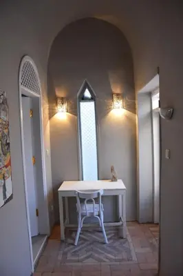 a white table with a chair in a room with two windows at HF - residency in Luxor