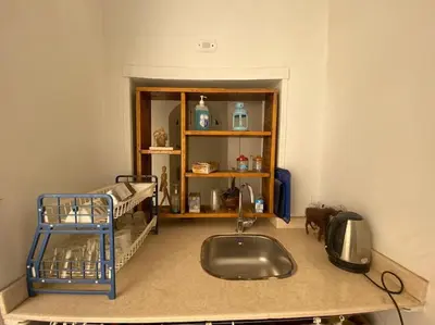 a kitchen with a sink and a bed in a room at HF - residency in Luxor