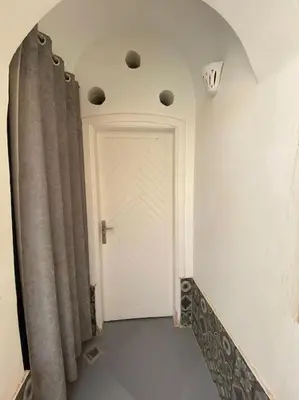 a hallway with a white door and a curtain at HF - residency in Luxor