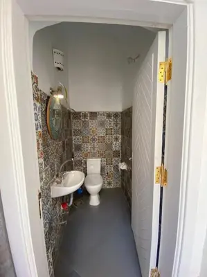 a small bathroom with a toilet and a sink at HF - residency in Luxor