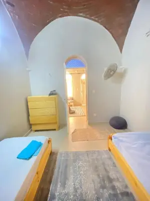 a room with two beds and a hallway with a mirror at HF - residency in Luxor