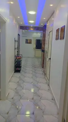 a hallway with a tile floor with a blue ceiling at اهلا بيكم في بيتنا in Jazīrat al ‘Awwāmīyah