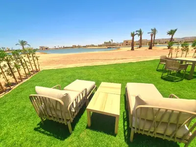 a group of chairs and tables on a grass field at شيدوان الجونة in El Gouna