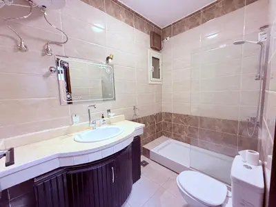 a bathroom with a sink and a toilet and a tub at Sheherazade Guesthouse in Luxor