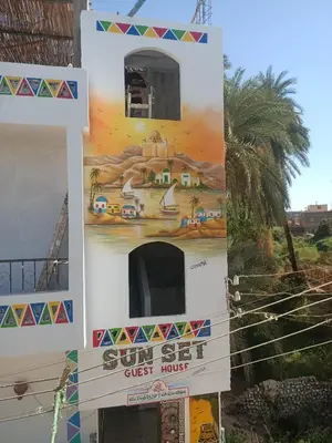 a building with a poster on the side of it at sunset guest house in Aswan