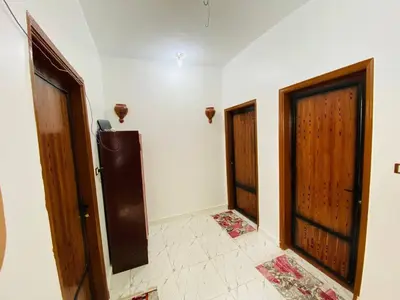 a room with two doors and a tile floor at sunset guest house in Aswan
