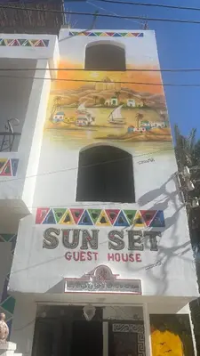 a sign on the side of a guest house at sunset guest house in Aswan