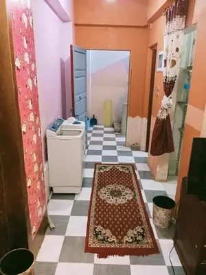 a hallway with a tile floor with a rug on it at الشواربي السياحي سوق الحارث in Aswan