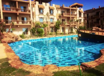 a large swimming pool in front of a building at Hurghada Jungle Clube House Compound 1 bedroom Хургада компаунд студия в Джангл с 1 спальней in Hurghada