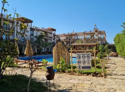a resort with a swimming pool and some buildings at Hurghada Jungle Clube House Compound 1 bedroom Хургада компаунд студия в Джангл с 1 спальней in Hurghada