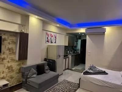 a room with a bed and a couch and a kitchen at Cecilia resort hurghadaمنتجع سيسيليا in Hurghada