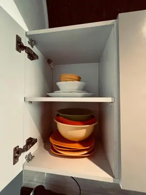 a cabinet with bowls and plates in it at Rooftop in Hurghada with seaview and private terrace in Hurghada