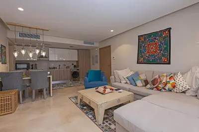 a living room with a couch and a table at Ollystays Mangroovy 1 BR Beach and Pool Free access in Hurghada