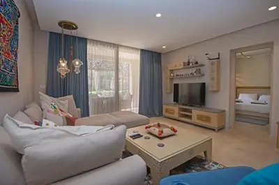 a living room with a couch and a table at Ollystays Mangroovy 1 BR Beach and Pool Free access in Hurghada