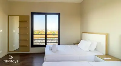 a bedroom with two beds and a large window at Ollystays 4BR Townhouse Shared Pool El Gouna in Hurghada