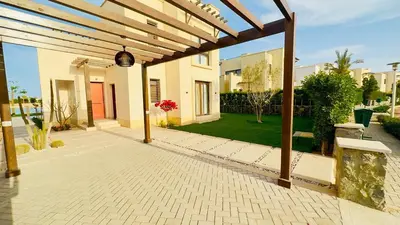 an outdoor patio with a wooden pergola at Ollystays 4BR Villa Heated Pool El Gouna in Hurghada