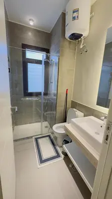 a bathroom with a shower and a toilet and a sink at Ollystays 4BR Villa Heated Pool El Gouna in Hurghada