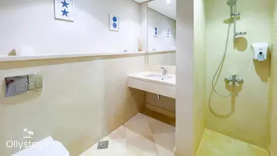 a bathroom with a sink and a shower at Ollystays Mangroovy 3BR Beach and Pool Free access in Hurghada
