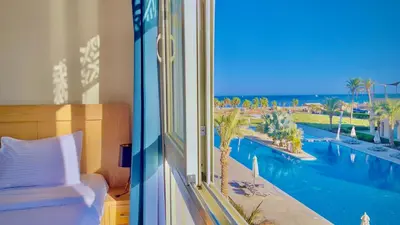 a hotel room with a view of a swimming pool at Ollystays Mangroovy Seaview 2BR Beach and Pool Free access in Hurghada