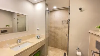 a bathroom with a sink and a shower at Ollystays Mangroovy Seaview 2BR Beach and Pool Free access in Hurghada