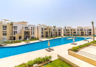 a large swimming pool in the middle of a building at Ollystays Mangroovy Seaview 2BR Beach and Pool Free access in Hurghada