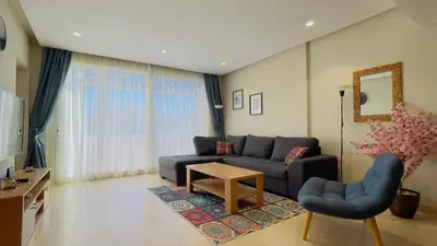 a living room with a couch and a table at Ollystays Mangroovy Seaview 2BR Beach and Pool Free access in Hurghada