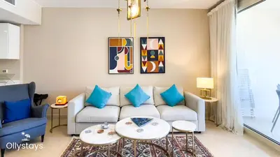 a living room with a couch and a table at Ollystays Mangroovy Seaview 2BR Beach and Pool Free access in Hurghada