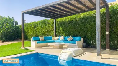 a patio with a couch and a swimming pool at Tawila 4BR Villa Private Pool in Hurghada