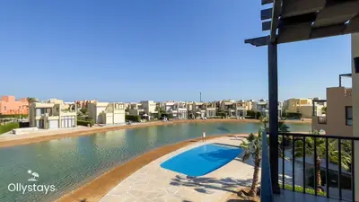 a view of a swimming pool from a building at Ollystays Tawila 2BR Apt Shared pool El Gouna in Hurghada