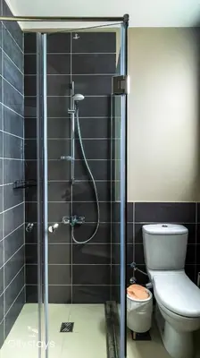 a bathroom with a glass shower with a toilet at Ollystays Tawila 2BR Apt Shared pool El Gouna in Hurghada