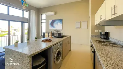 a kitchen with a washer and dryer on a counter at Ollystays Tawila 2BR Apt Shared pool El Gouna in Hurghada