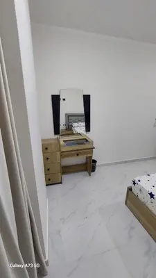 a white room with a mirror and a dresser at الغردقه in Hurghada