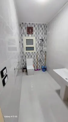 a white bathroom with a toilet and a sink at الغردقه in Hurghada